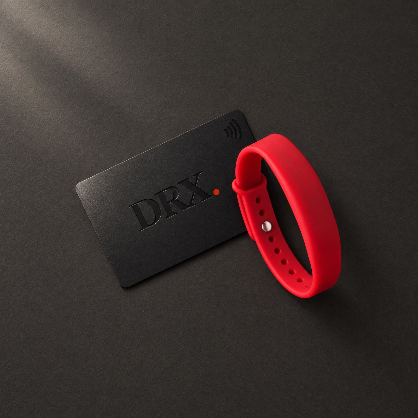 Black DRX tap card beside a red DRX tap bracelet
